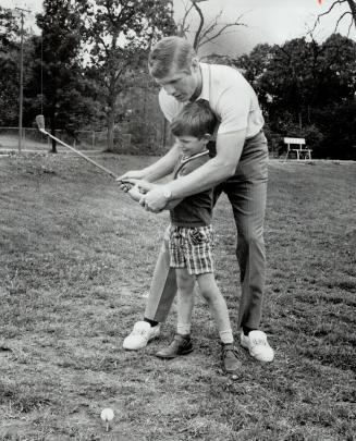 Hockey Star Vic Hadfield, of the New York Rangers, who is also golf pro at the Lido Golf Centre, gives his 5-year-old son Jeffery some tips on improvi(...)
