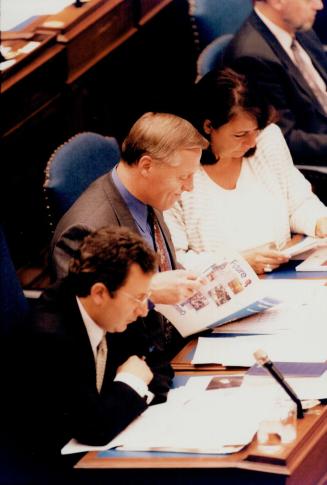 Bad news: NDP Leader Howard Hampton, centre, grimaces as as he reads budget detail with MPPs Frances Lankin and Tony Silipo