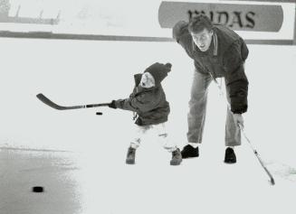 Chip off the old block: Three-year-old Jeffrey Hannan works on his slapshot under the watchful eye of his dad, the Leafs' Dave Hannan