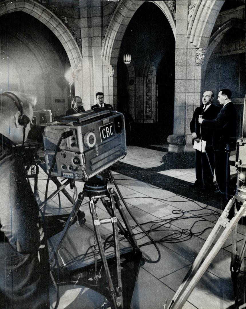 The resignation of Defence Minister Douglas Harkness, here explaining his nuclear arms stand in the rotunda of the House of Commons, helped bring abou(...)