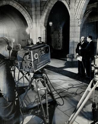 The resignation of Defence Minister Douglas Harkness, here explaining his nuclear arms stand in the rotunda of the House of Commons, helped bring abou(...)