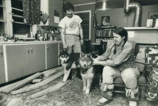 Frobisher Bay: Enook and Suzanne Manomie at home building a kamotik in the living room