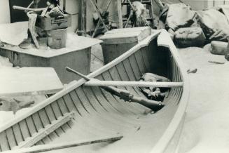 Lots of guns were left out like this, and boats are carried on sleds by seal hunters who go out to the floe edge, in Pangnirtung