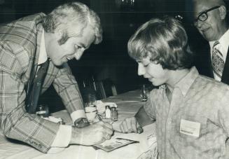 Old carrier boy Billy Harris signs his autograph for new carrier boy Claudio Hamburgo, 15, at The Star Carrier Grand Awards dinner last night. Harris,(...)
