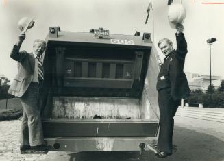 All-Canadian garbage Mayor Gus Harris (left) and Consumers Affairs Minister Frank Drea tossed the first bags of garbage into the borough's first Canad(...)