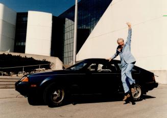 What a fun guy! Scarborough Mayor Gus Harris kicks up his heels alongside his sporty Toyota Celica coupe
