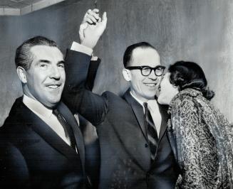 Congratulations for Progressive-Conservative winner in Beaches, Jack Harris: Controller Don Summerville raises his arms while his wife, Mary, plants a kiss on his cheek