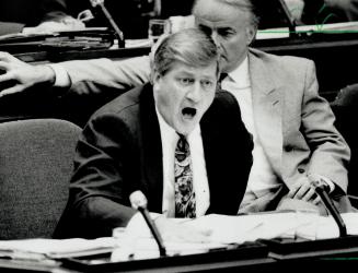 He's hot: Conservative Leader Mike Harris, left, lambastes Premier Bob Rae in the Legislature yesterday over NDP scandals