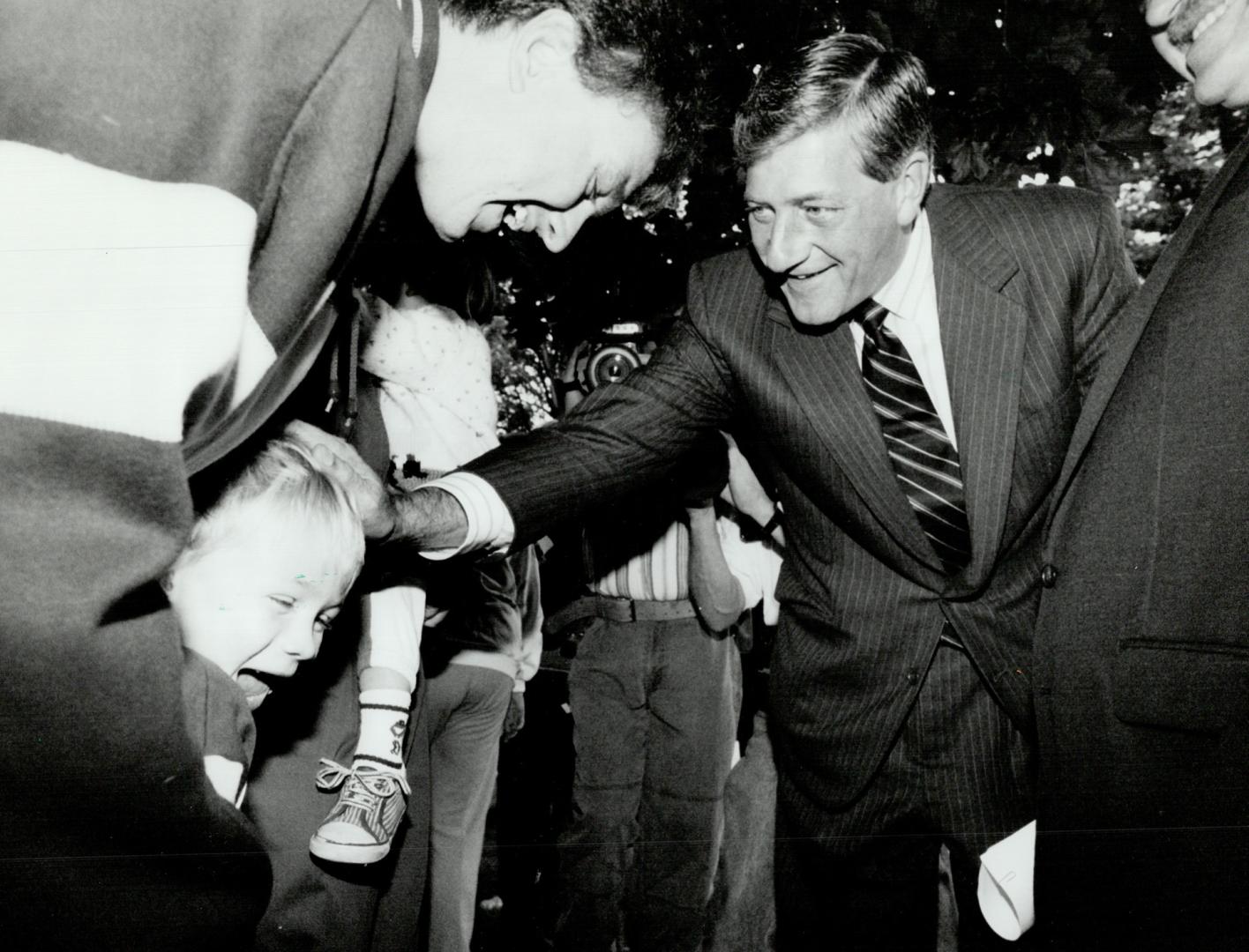 Shy admirer: Four-year-old Jordan Dysart doesn't know quite what to do yesterday when Progressive Conservative leader Mike Harris introduces himself in Whitevale