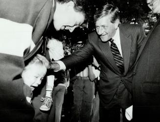 Shy admirer: Four-year-old Jordan Dysart doesn't know quite what to do yesterday when Progressive Conservative leader Mike Harris introduces himself in Whitevale