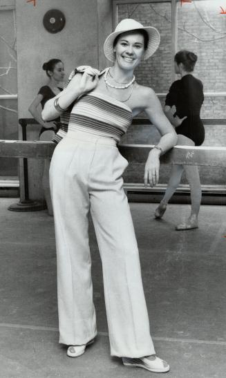 Vanessa Harwood, one of five travelling ballerinas, has chic look in beige pants and beige-blue striped sweater with a matching cardigan