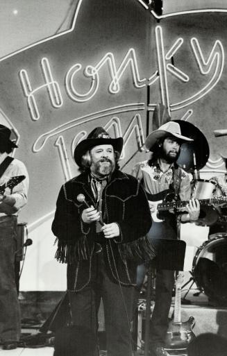 Rompin' Ronnie Hawkins has fringed deerskin coat with feather and bead appliqu?