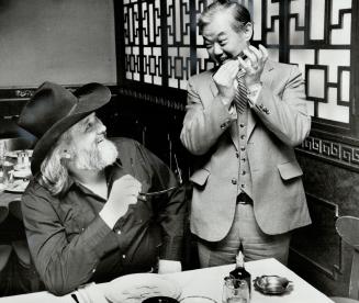 Asian cowboy' Bill Wen, part-owner of Sai Woo restaurant, performs on the harmonica for his old friend, Rompin' Ronnie Hawkins. The Hawk spends a lot of time there eating octopus soup
