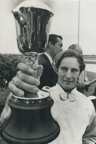Sandy Hawley proudly shows his trophy as jockey on Queen's Plate winner Almoner