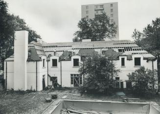 Image shows a mansion under demolition.