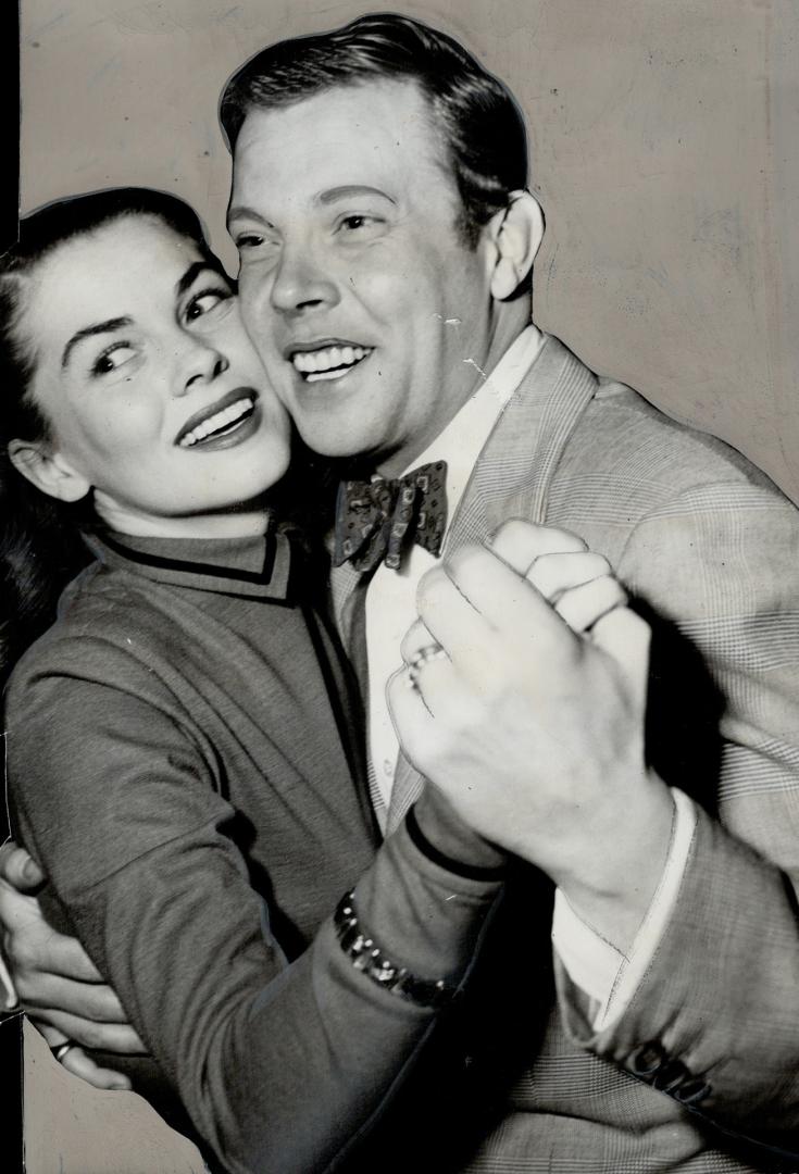 Cheek-to-cheek, Dick Haymes and his actress wife, Joanne Dru, were snapped at a dance