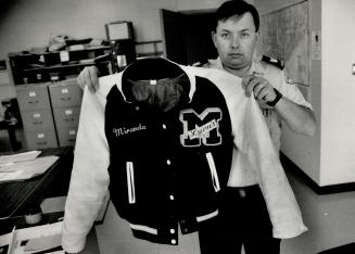 Metro police Sergeant Stephen McCarthy holds the jacket of 14-year-old Benji Hayward, whose body was found today floating in Lake Ontario. The jacket (...)