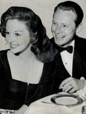 Jess Barker and his screen star wife, Susan Hayward, are all set for dinner in a Hollywood restaurant after seeing twin two-year-old sons safely tucked in bed