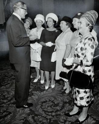 Tory leadership contender woos campaign support: At Toronto reception, George Hees chats with attentive group of women