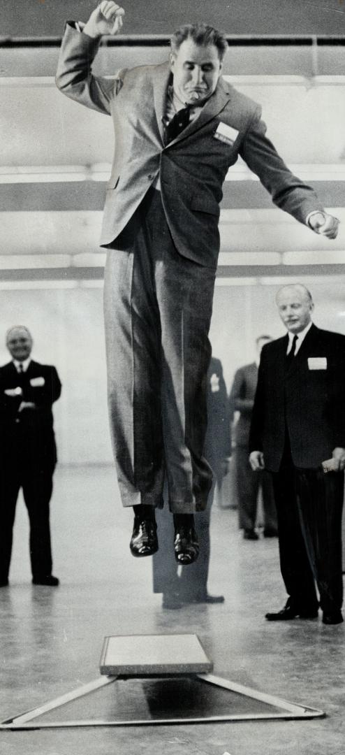 Just testing: George Hees, Progressive Conservative candidate in Broadview, tests a springboard during visit to Canadian Samples Show at the CNE grounds today