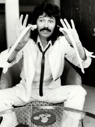 The hand and hankie are quicker than the eye as Doug Henning hams it up with a simple trick