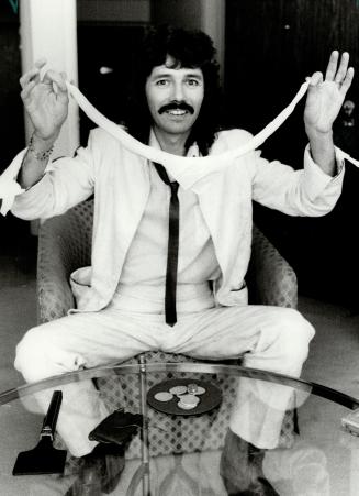 The hand and hankle are quicker than the eye as Doug Henning hams it up with a simple trick
