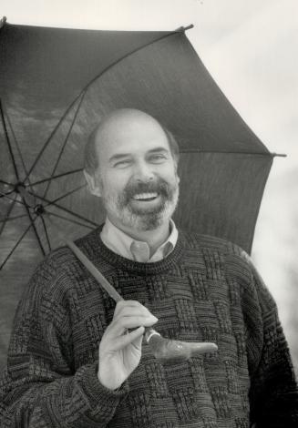 Unusual umbrella: Right, magazine publisher Peter Herrndorf sings in the rain with a mallard head handled umbrella, $50
