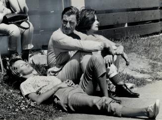 World champion driver Graham Hill relaxes before race: Lisa Penske, on right, and Angeline Rodriguez, also relax