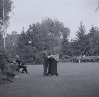 Image shows people gathered for an opening ceremony at the Edwards Gardens.