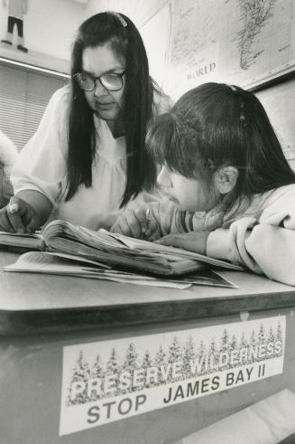 Hard Lesson: Cree school teacher Emily Masty, helps Grade 6 pupil Linda George