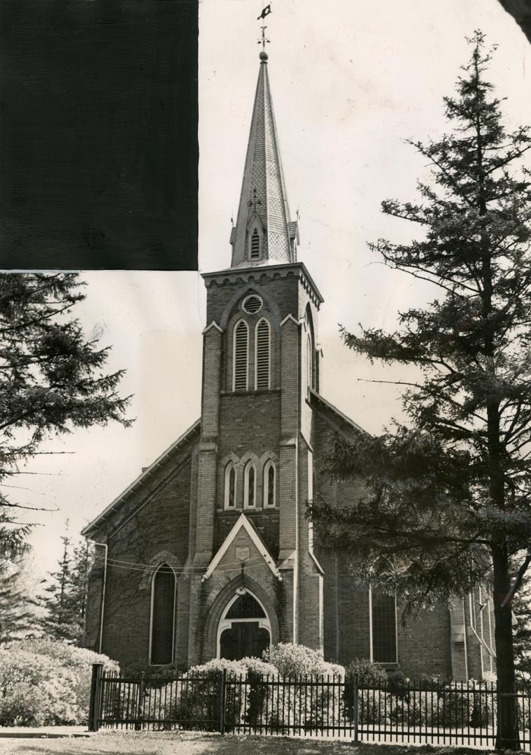Front of church; entrance below belfry tower and spire. Lancet windows either side of entrance.…