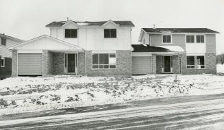 Two attached houses, that appear to be single and detached, are among those offered by a builder in Burlington who has introduced semi-detached houses in an area where single houses predominate