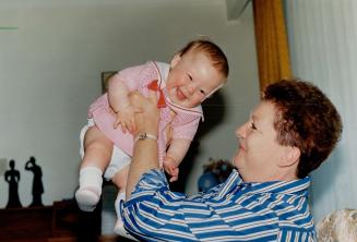 Celeste Hinds plays with her 11-month-old daughter Maria yesterday at a friend's home in Mississauga