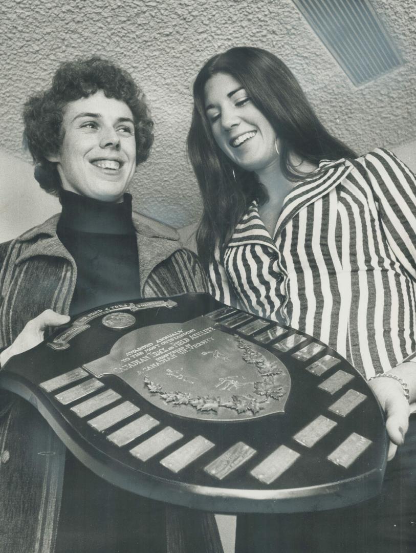 Champions Honored: Debbie van Kiekebelt (right) admires award presented to Abby Hoffman (left) as top track and field athlete in Central Ontario