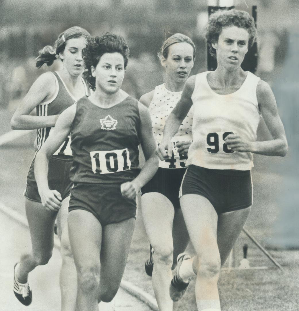 Racing from back of the pack. Debbie Mitchell (left at back) of Toronto won women's 1:500-metre race Saturday at Etobicoke Guardian track meet at Cent(...)