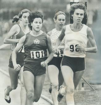 Racing from back of the pack. Debbie Mitchell (left at back) of Toronto won women's 1:500-metre race Saturday at Etobicoke Guardian track meet at Cent(...)