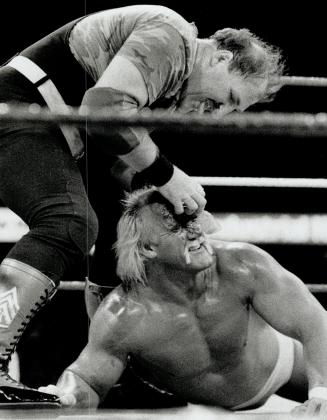 The hustler gets slaughtered: The villainous Sergeant Slaughter gouges Hulk Hogan's eyes in WWF championship match last night at the Gardens