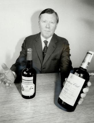 All his to keep: Sir Derrick Holden Brown: chairman of Allied-Lyons PLC: shows some of the products of Hiram Walker's liquor operations: which his London-based company now controls
