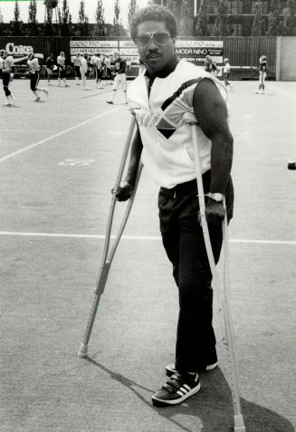 On the sidelines: Argo quarterback Condredge Holloway: moving gingerly on crutches after Saturday's surgery on his left knee: was a surprise observer at yesterday's team workout