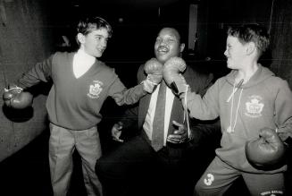 This guy don't look so tough to me': Matt Sheedy and Scott Manson: both 9 years old: give former world heavyweight champion Larry Holmes the old 1-2 yesterday at the Ontario Science Centre