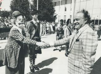 Clown meets clown: Comedian Bob Hope: who officially opened the Canadian National Exhibition today: is greeted by CNE clown Fifi