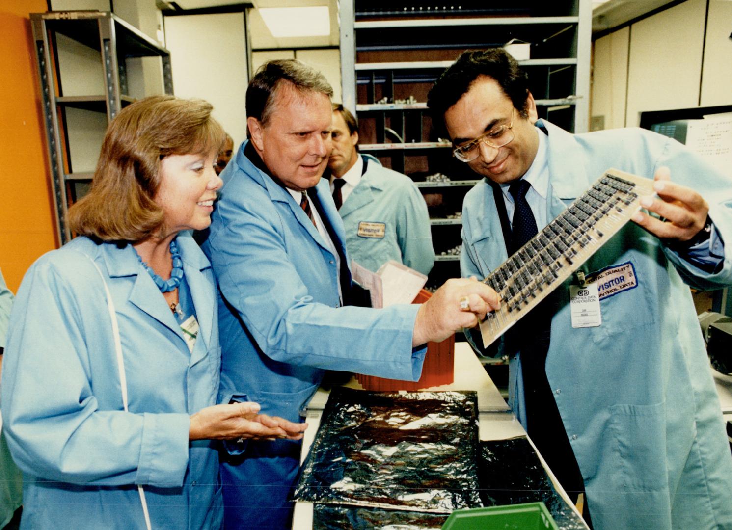 High-tech tour: MP Bob Horner (middle) and his wife Elayne get a peek from general manager of manufacturing Sam Madan at the inner workings of one of Control Data Canada's computers