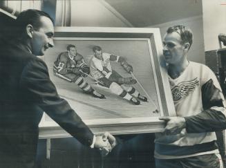 In oils and actuality. Detroit Red Wings' great Gordie Howe admires painting of himself in action: presented in honor of his 600th NHL goal by Will Kl(...)