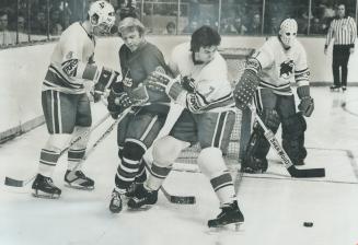 Bobby Hull (9) is covered like a blanket by Toro players in last night's game