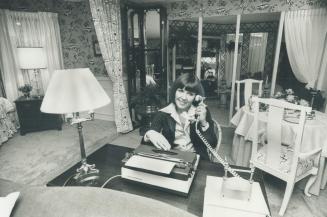 Helen Hutchinson, television personality, sits in bed-sitting room designed for her