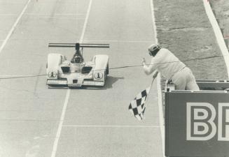 Jacky Ickx: driving No. 1 car, gets signal from official that he has won yesterday's Can-Am race at Mosport