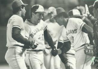 The glad hands: Jays' Garth lorg was the happy centre of attention of teammates Damaso Garcia: left: and George Bell after his two-run single lifted Jays to exciting come-from-behind win