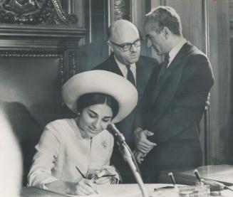 The Shah of Iran and Empress Farah were welcomed at Montreal's city hall by Mayor Jean Drapeau