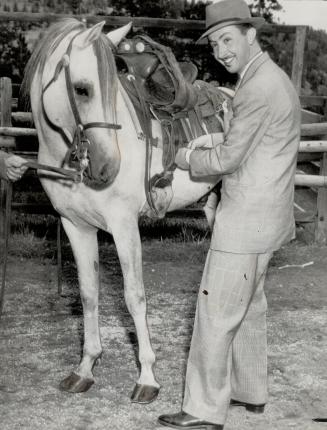 Arab meets Arab here as Emir AbdulIlah, prince regent of Iraq, saddles Sahar, an Arab steed of royal blood, in the west