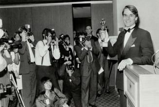 Snapping up Genie: Jeremy Irons poses for a pack of show-biz paparazzi after winning Best Actor award last night